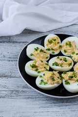 Home eggs stuffed with cheese and crab topped with green onions