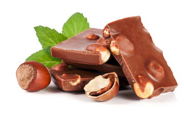 Chocolate with hazelnut and mint leaf isolated on white background