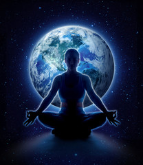 Fototapeta na wymiar Yoga woman on the world. Meditation girl sitting in lotus pose on planet earth and star in dark night sky, Moon original image from NASA.gov