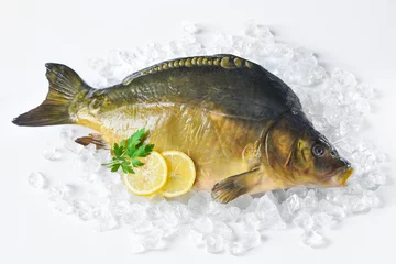 Rolgordijnen Fresh carp with lemon on ice © Alexander Raths