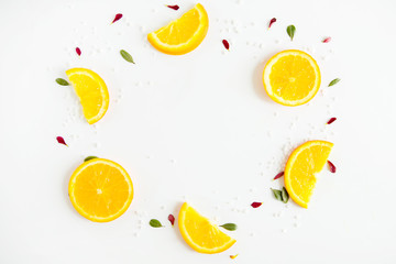 Spa background of petals, slices of orange and salt. Composition on white background. Flat lay, top view.