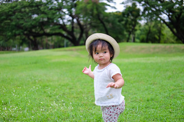 Cute Baby girl playing in the garden, close-up portrait, Portrait of Asian beautiful baby girl of 1 year and 3 months old.