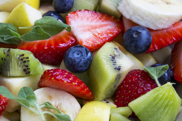 Fruits salad macro with strawberries, blueberries,kiwi, apples and bananas