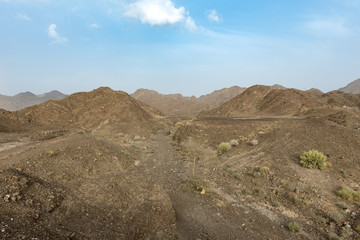 Beautiful View of Wadi in United Arab Emirates with Blue Sky and Clouds. 