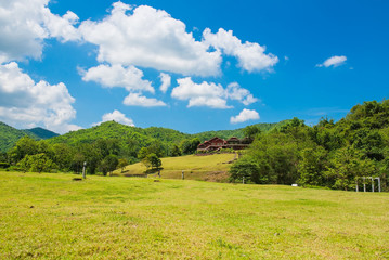 wooden house on mountain In the summer. Cloud and blue sky background. 