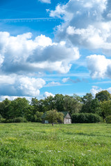 Small country farmhouse out on the field. Dobele, Latvia.