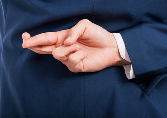 Fototapeta premium Closeup of man hand doing a cheating gesture