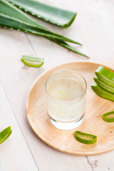 Aloe vera yogurt with fresh leaves on a wooden table