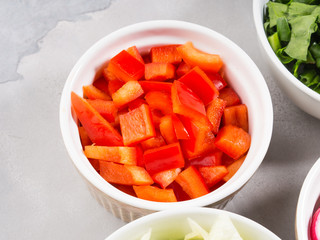 Mix of vegetable bowls for salad or snacks on gray background. Diet detox concept. Cook with bell peppers