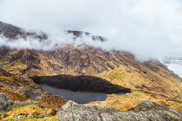 A beautiful irish mountain landscape with a lake in spring. Gleninchaquin park in Ireland.
