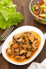 mussels in sauce on white dish