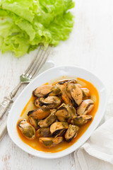 mussels in sauce on white dish
