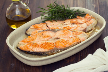 fried salmon on dish on wooden background