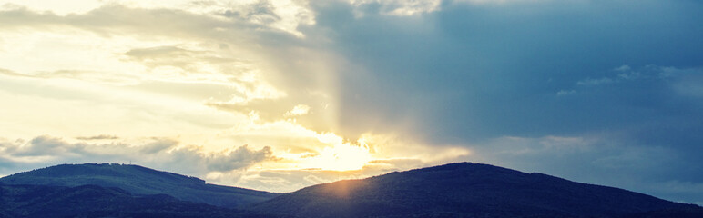 sunset above hills