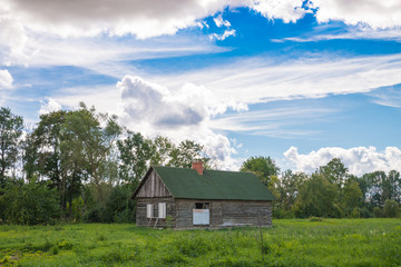 Fototapeta na wymiar Small country farmhouse out on the field. Dobele, Latvia.