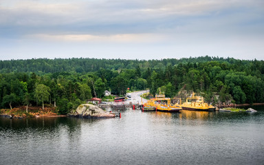 Obraz premium Turku, Finland, July 25 2015. Two car ferrys with landscape at summer evening in coastline, Finland