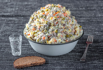 Russian traditional salad olivier with vodka and black bread, New Year. Moscow, Russia