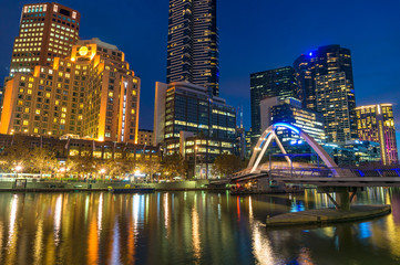Plakat Beautiful cityscape at night with bridge across river