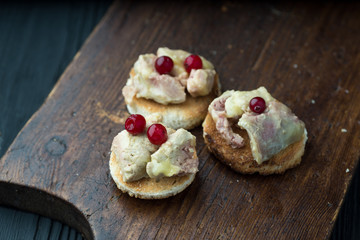 Foie gras on sandwiches and red Cranberries.