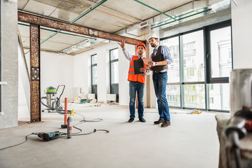 Fototapeta premium Interested builders discussing question of renovation