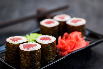 Fresh delicious tuna maki sushi rolls on dark background