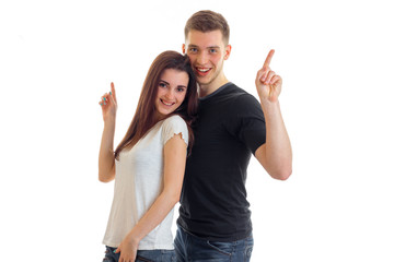 fun loving couple standing next to each other show fingers gesture and smiling