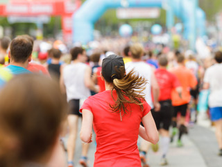 Woman running at marathon at start / finish