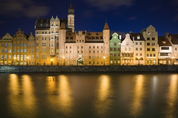 Fototapeta na wymiar Long Embankment and Motlawa River in the Old Town of Gdansk, Poland at night. Mariacka Gate in the center