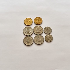 US currency coins; a dollar, fifty cent, quarter, nickel, dime and penny, isolated on white