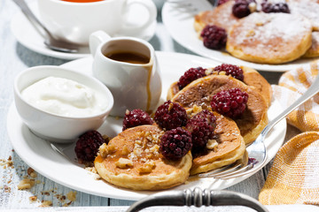 sweet corn pancakes with berries and caramel sauce, closeup