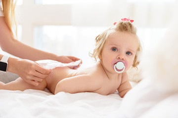 Cute little child having diaper changing
