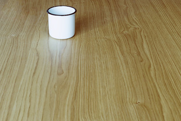 Metal cup on wooden table