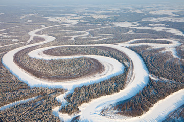 Bird eye view onto forest river in winter