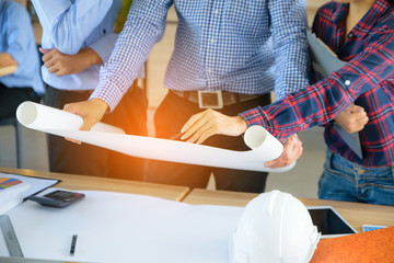 Close up Architects Hands Working with Engineering on blueprint background