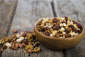 Nuts in a wooden bowl  on a  wooden table