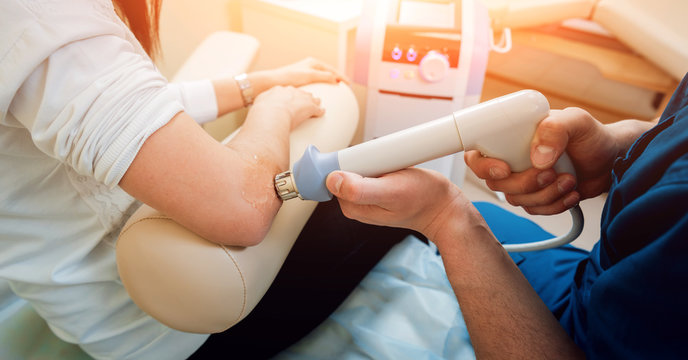 Shock Wave Therapy. The Magnetic Field, Rehabilitation. Physiotherapist Doctor Performs Surgery On A Patient's Elbow