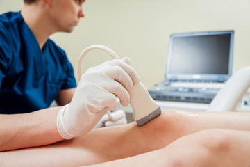 Patient with orthopedist doctor in his office.