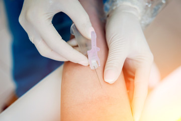 Closeup of nurse's hands taking a blood sample