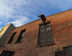 Troy NY street scene at dusk/sunset with historic buildings, traffic and activity on a Friday night.