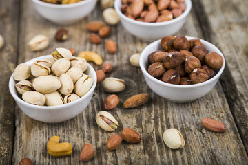 Nuts in a plate on a  wooden table