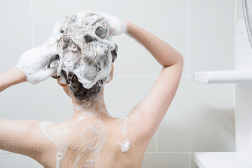 woman in shower washing hair with shampoo - obrazy, fototapety, plakaty