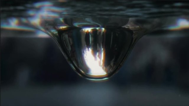 Crowd reflecting in the drop of water. Timelapse.