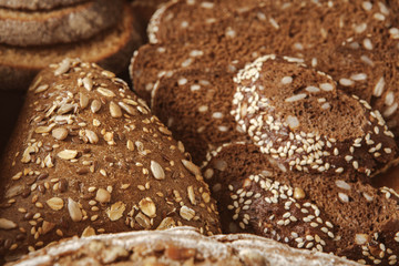 Bread background, closeup of white, black and rye loaves