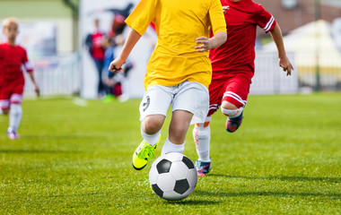 Running Youth Soccer Football Players. Boys Kicking Soccer Match. Children Football Players Running...