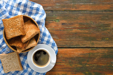 Breakfast background, toast and coffee on rustic wood, top view