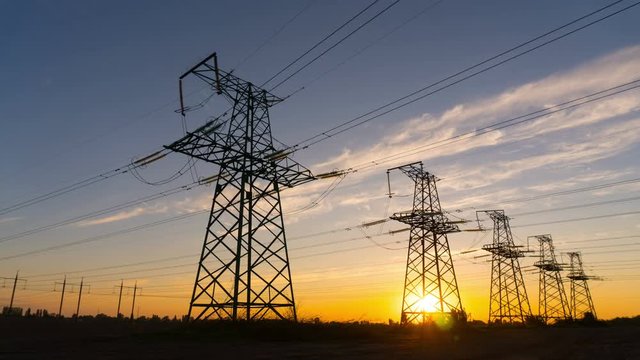 Time lapse - Electricity pylons at sunset. Concept: power, electric, energy, energetics
