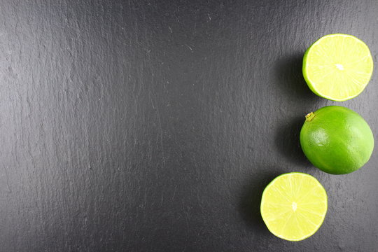 fresh lime fruit on a slate plate food background texture