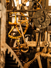 Clockwork mechanism. Close up view of cog wheels and other mechanical parts of vintage tower clock.
