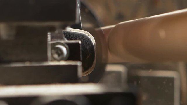 Close up footage of working turning machine in slowmotion in joinery