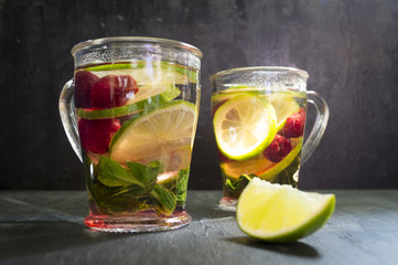 mint tea with lime and cherry. dark photo